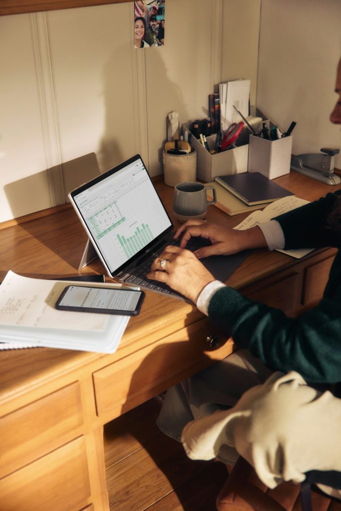 Business professional working on laptop — ChatGPT Work agentic AI browser automation for business tasks